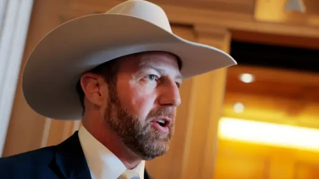 Mulling wearing a cowboy hat