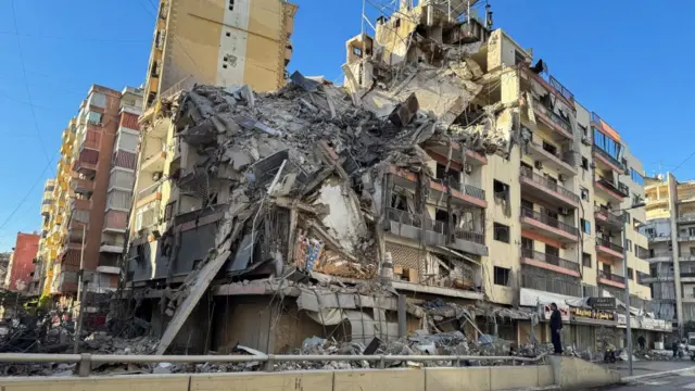 A building is reduced to rubble on a street in Beirut