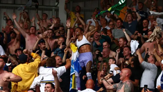 Raphinha celebrates with Leeds fans