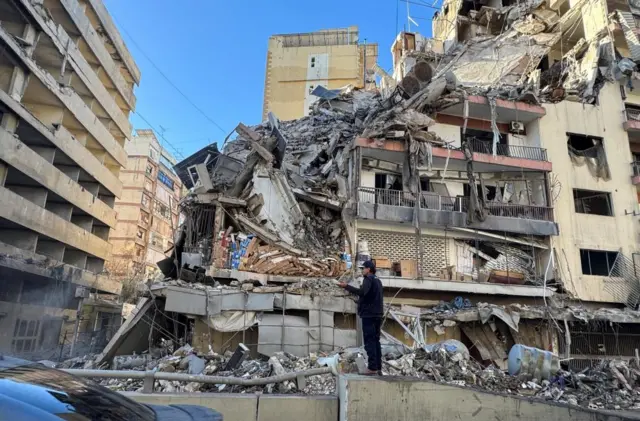 A man standing in front of a damaged building in Beirut on Thursday
