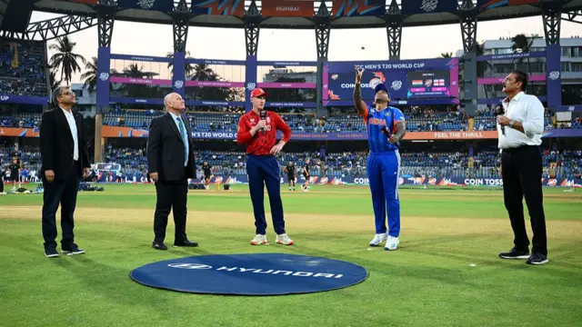 Suryakumar Yadav of India tosses alongside England captain Harry Brook ahead of the ICC Men's T20 World Cup India & Sri Lanka 2026 Semi-Final match between India and England