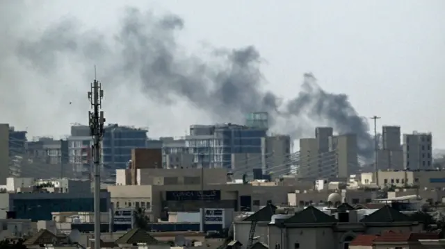 A plume of smoke rises over buildings in Doha