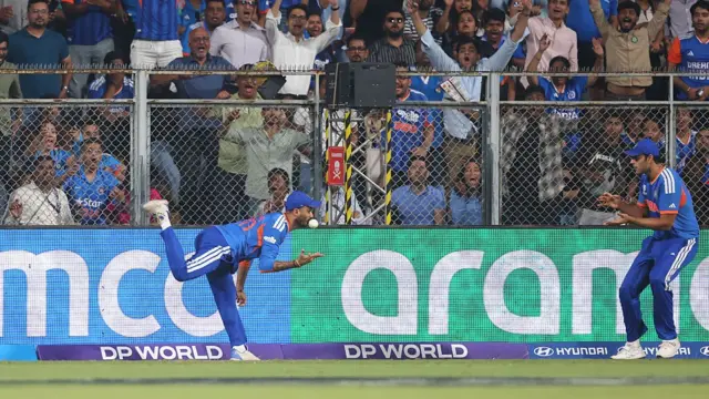 Axar Patel of India flicks the ball to team mate Shivam Dube to catch Will Jacks of England
