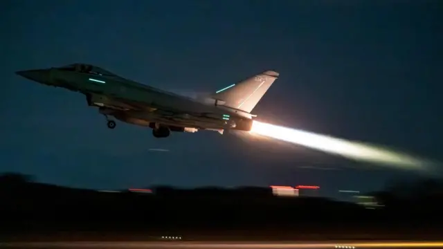 A jet taking off in the night sky