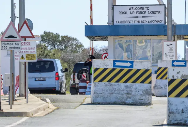 Entrance to RAF Akrotiri with guard saluting as a car enters