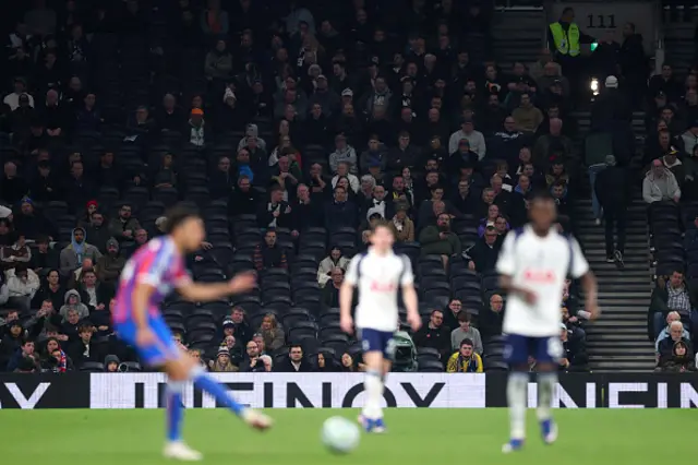 Fans of Tottenham Hotspur are seen walking towards the exit
