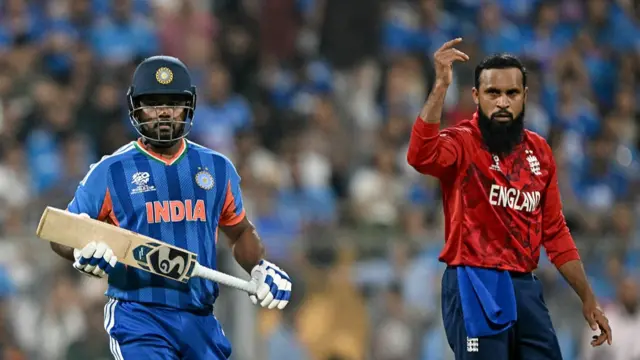 India's Sanju Samson (L) runs between the wickets as England's Adil Rashid
