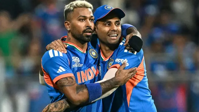 India's Hardik Pandya (L) celebrates with his captain Suryakumar Yadav after taking the wicket of England's Phil Salt