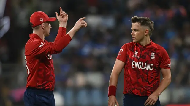 : England captain Harry Brook speaks with Sam Curran