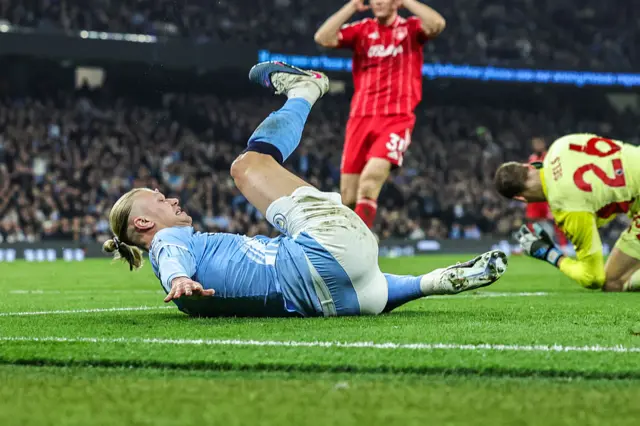 Haaland goes down after a challenge by Matz Sels.