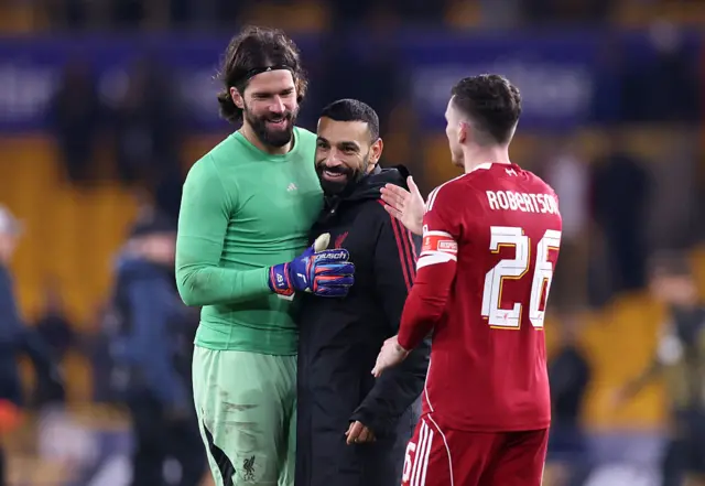 Alisson, Mohamed Salah and Andy Robertson celebrate