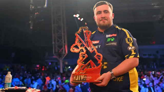 Luke Littler holds the UK Open trophy