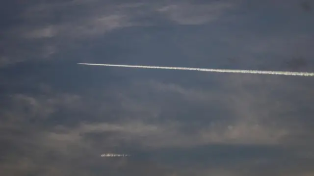 A white jet line visible in the sky