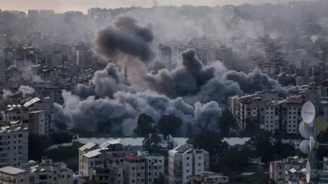 Thick grey smoke over dense urban areas