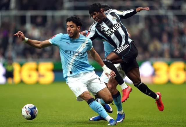 Newcastle United's Anthony Elanga (right) and Manchester City's Omar Marmoush battle for the ball