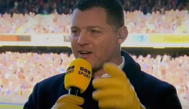 Benjamin Kayser is sporting a pair of wacky yellow gloves