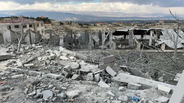 Damage from strikes in the village of Nabi Chit in the Bekaa Valley in eastern Lebanon. Rubble from destroyed buildings is visible.