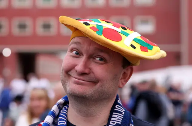 Fan with a pizza hat