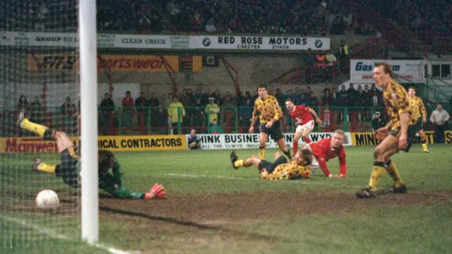 Wrexham striker Steve Watkin scores the winning goal against Arsenal in 1992