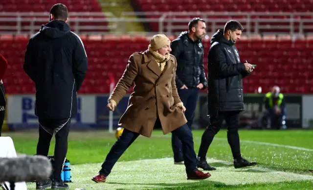 Swindon Town boss Ian Holloway celebrating his side's second goal from the touchline, clenching his fists with his mouth open.