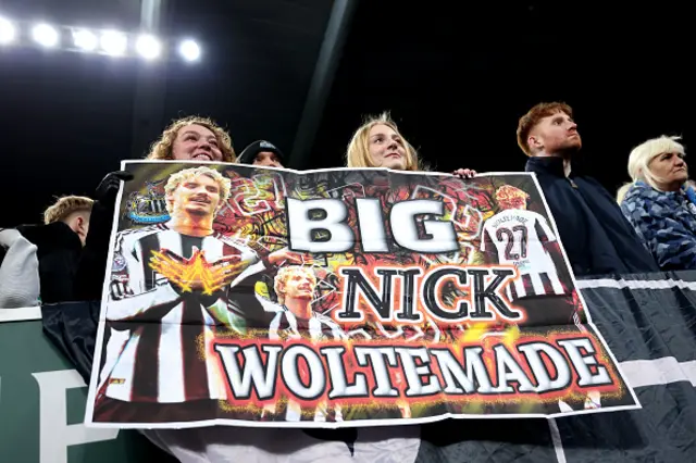 Fans hold a banner with Nick Woltemade name on it