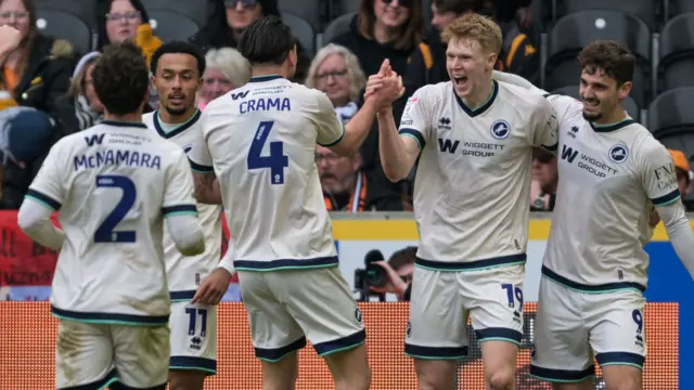 Millwall players celebrate a goal in the 3-1 win at Hull City
