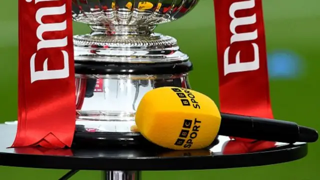 A BBC Sport microphone is pictured next to he FA Cup Trophy