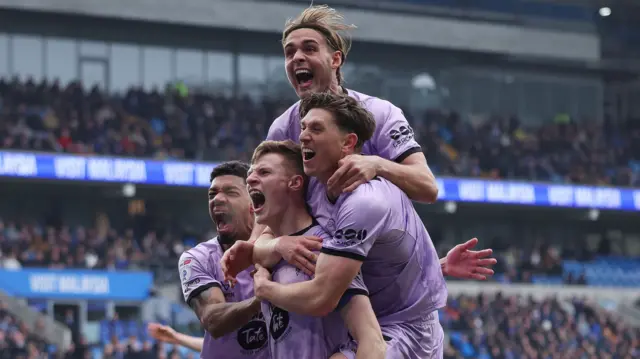 Lincoln players celebrate their opening goal at Cardiff