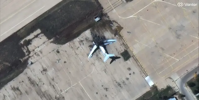 Image shows a burned out plane on a runway