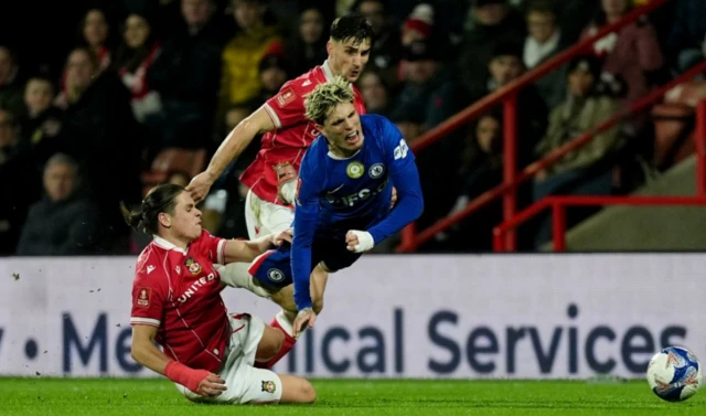 Wrexham's George Dobson (left) fouls Chelsea's Alejandro Garnacho for which he received a red card