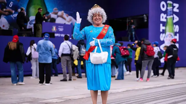 A woman dressed up like Queen Elizabeth II