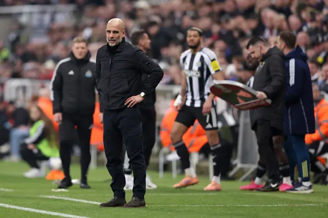 Pep Guardiola, Manager of Manchester City, looks on