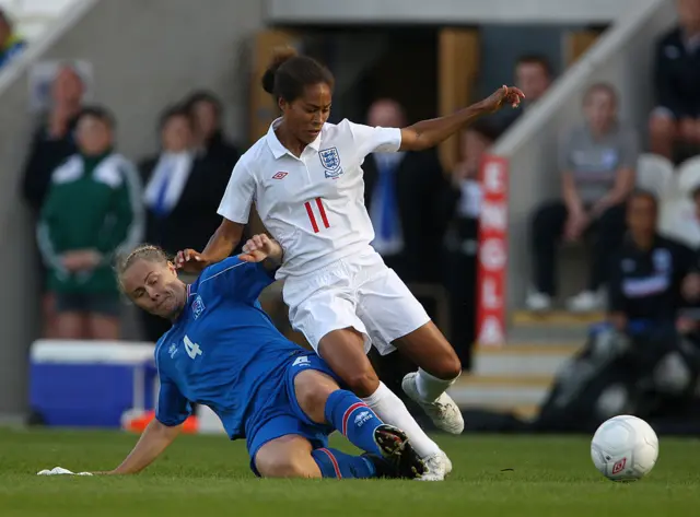 Yankey gets tackled by an Iceland midfielder