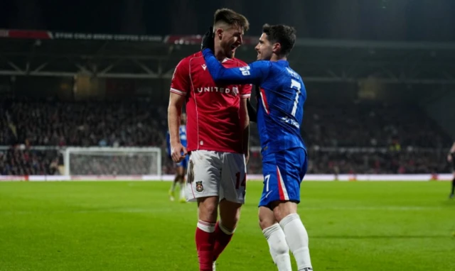 Wrexham's George Thomason (left) and Chelsea's Pedro Neto share a joke