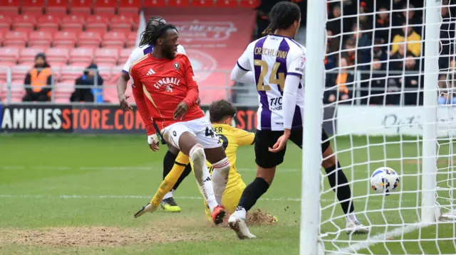 Rosaire Longelo of Salford City scores the opening goal against Barnet.