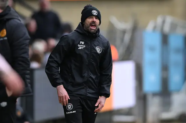 MK Dons boss Paul Warne shouts at his side from the touchline.