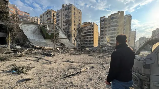A man inspects damage buildings after an Israeli strike on Beirut's southern suburbs