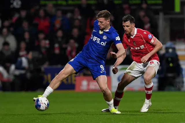 Liam Delap is put under pressure by Wrexham's Scottish defender Dominic Hyam