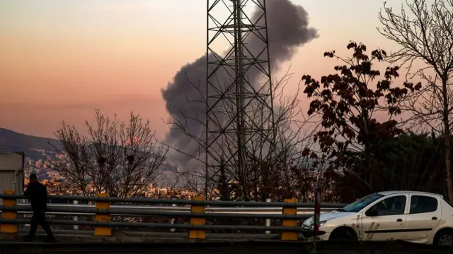 A general view of Tehran with smoke visible in the distance after explosions were reported in the city on March 06, 2026