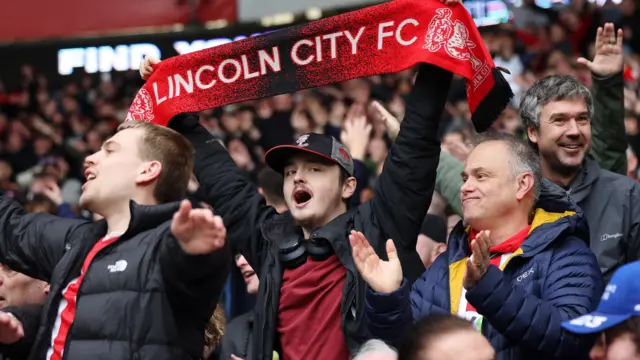 Lincoln fans celebrate their win at Cardiff