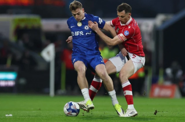 Wrexham's Dominic Hyam in action with Chelsea's Liam Delap