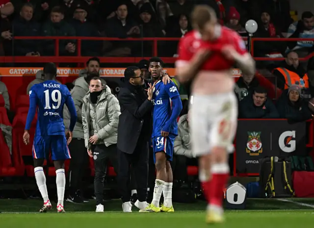 Liam Rosenior, Manager of Chelsea, speaks to Josh Acheampong