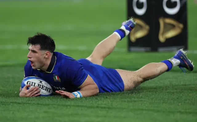 Italy's Tommaso Menoncello scores a try
