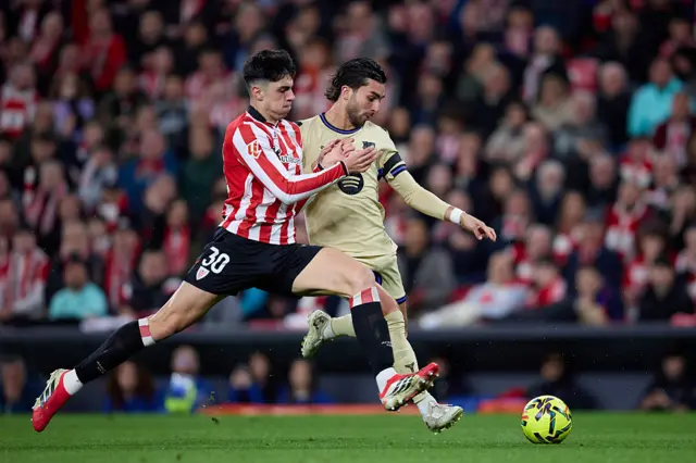 Alejandro Rego of Athletic Club challenges for the ball with Ferran Torres of FC Barcelona