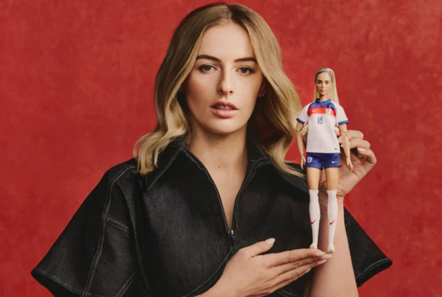 Chloe Kelly poses with the Barbie doll of her likeness