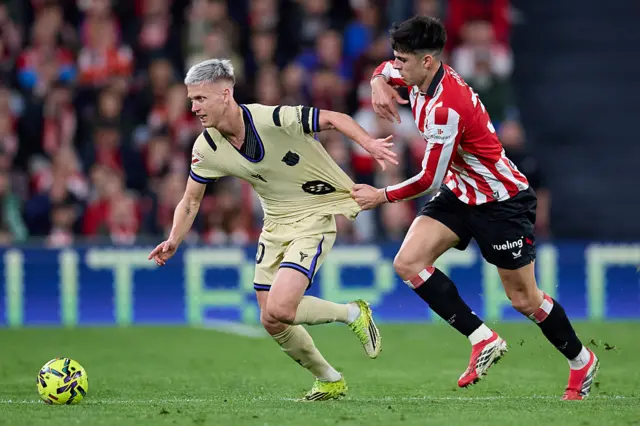 Dani Olmo of FC Barcelona carries the ball whilst under pressure from Alejandro Rego of Athletic Club