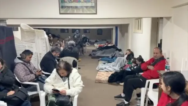 People sit in small hall in southern Lebanon