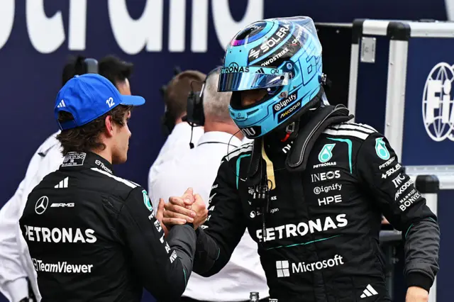 Kimi and George shake hands