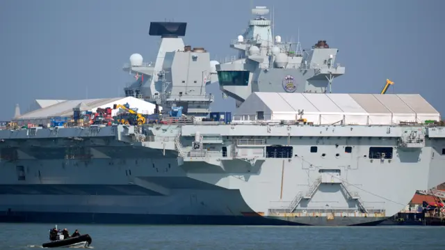 The Royal Navy aircraft carrier HMS Prince of Wales in dock at Portsmouth harbour, Hampshire. Picture date: Wednesday March 4, 2026. PA Photo. The UK will send helicopters with counter-drone capabilities and HMS Dragon, one of the Royal Navy's six Type 45 air defence destroyers, after RAF Akrotiri on Cyprus was hit by a drone.