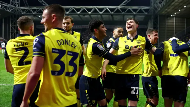 Oxford United players celebrate a goal in their 3-1 win at Preston